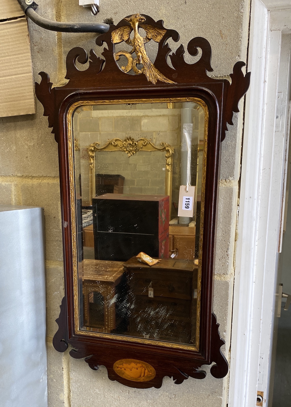 A George III style inlaid parcel gilt mahogany fret cut wall mirror, width 49cm, height 90cm